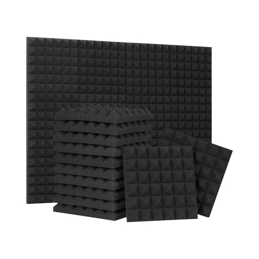 Black acoustic foam panels with a pyramid design, stacked and arranged for soundproofing or noise reduction applications.
