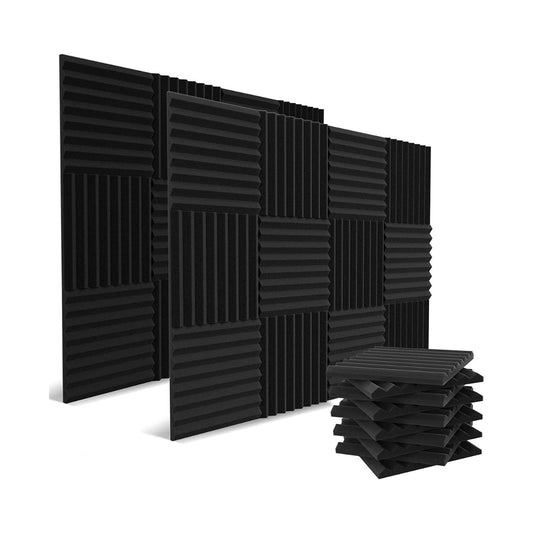 A set of black acoustic foam panels arranged in a pattern, designed for soundproofing and noise reduction, with extra panels stacked nearby.